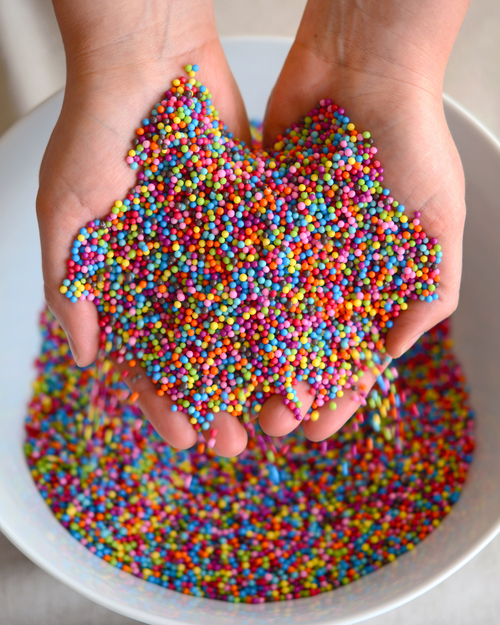 Colored sprinkles in hands