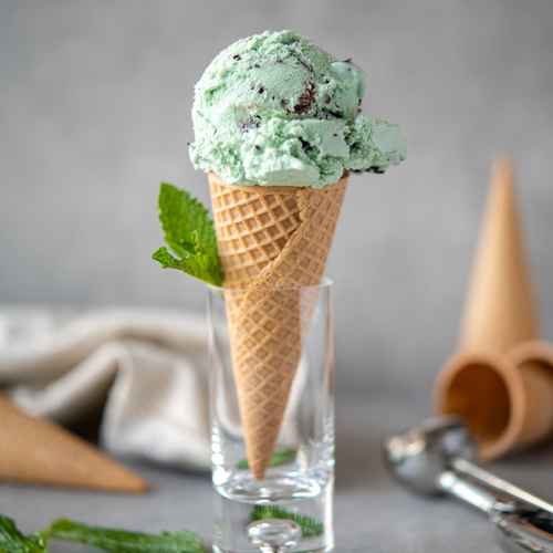 Green ice cream in a cone